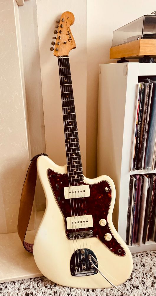 1961 Fender Jazzmaster Electric Guitar with Slab Rosewood fretboard. stood next to some records and a badly plastered wall.