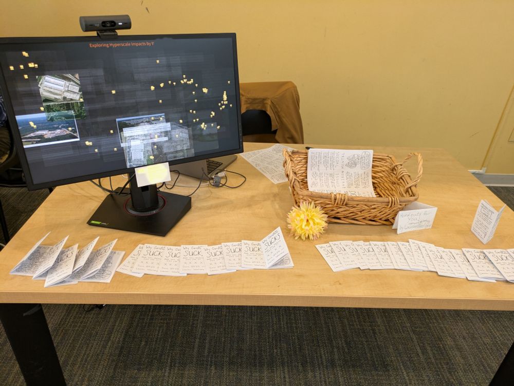 GenAI Sucks zine arranged next to a computer running an interactive video toy