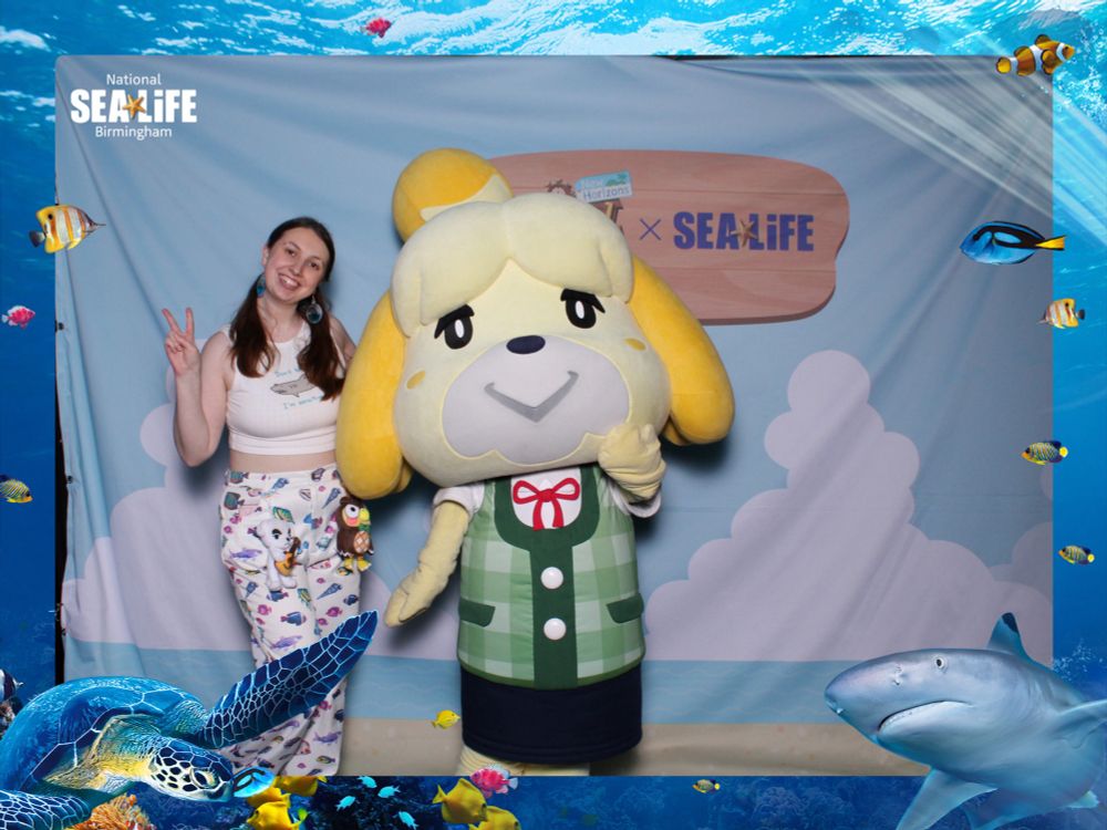 me meeting isabelle at the sealife x animal crossing event with a sealife frame