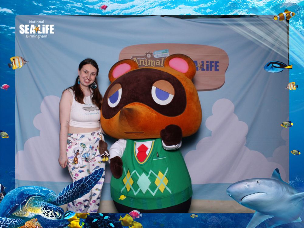 me meeting tom nook at the sealife x animal crossing event with a sealife frame