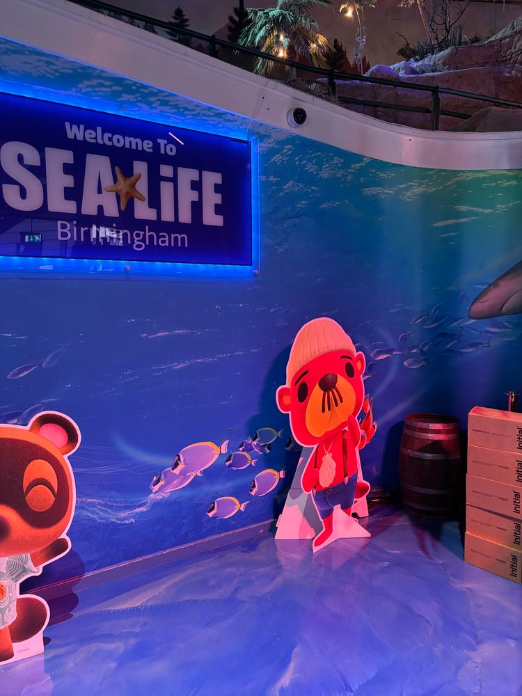 a photo cutout of timmy and tommy and pascal with sealife centre signage at the animal crossing x sealife event