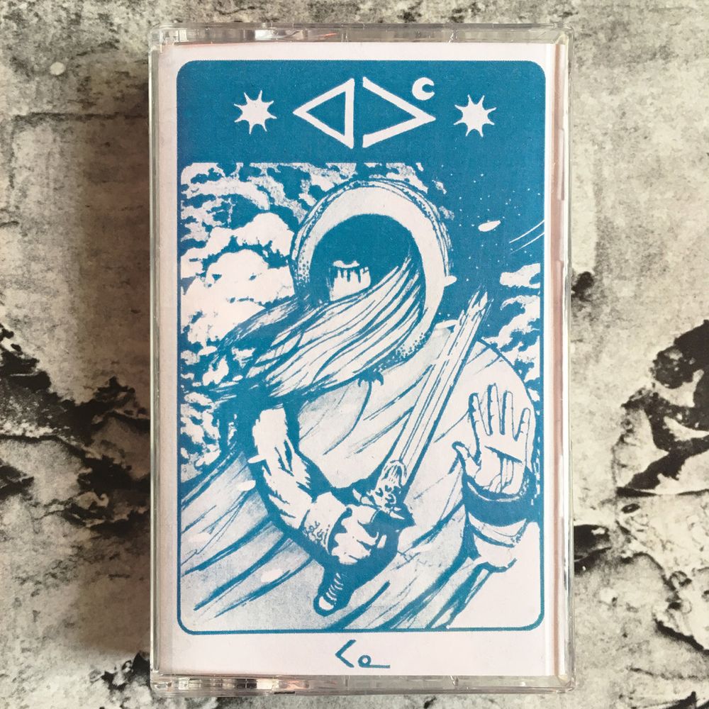 Album cover. Photo of a cassette depicting a person standing outside in the snow, with a broken sword and a cut palm.