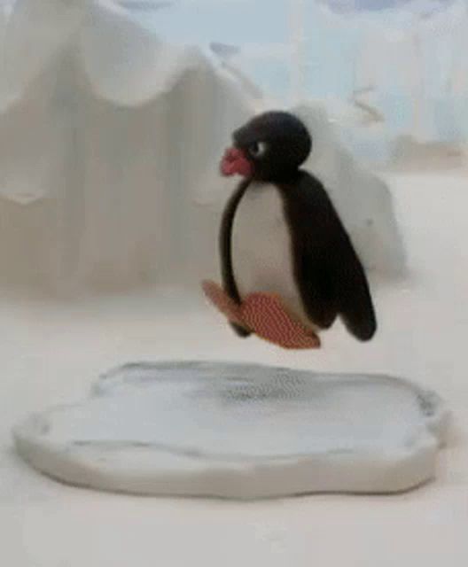 a penguin is standing on a piece of ice .