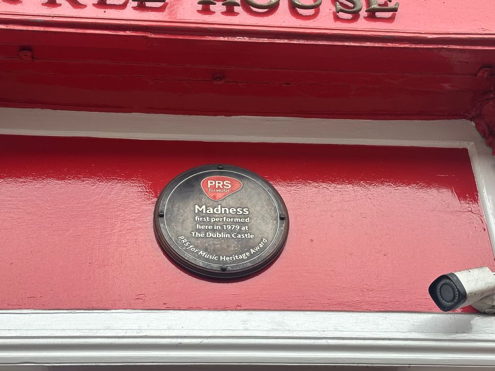 Plaque over the front door, reads “Madness first performed here in 1979.”