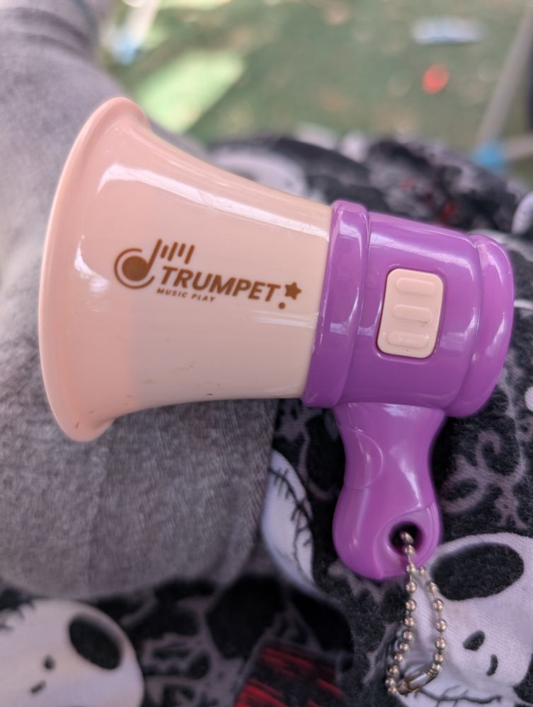 A megaphone keychain that says TRUMPET