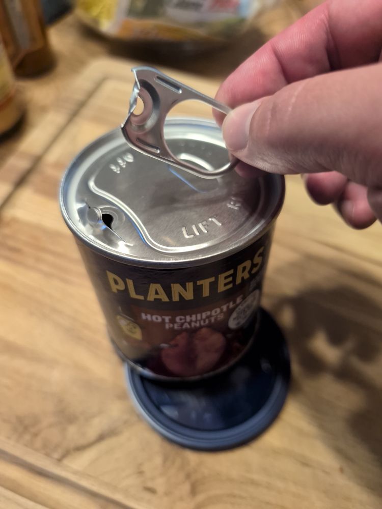Can of peanuts with the pull ring broken. The can must now be opened with a pen knife.