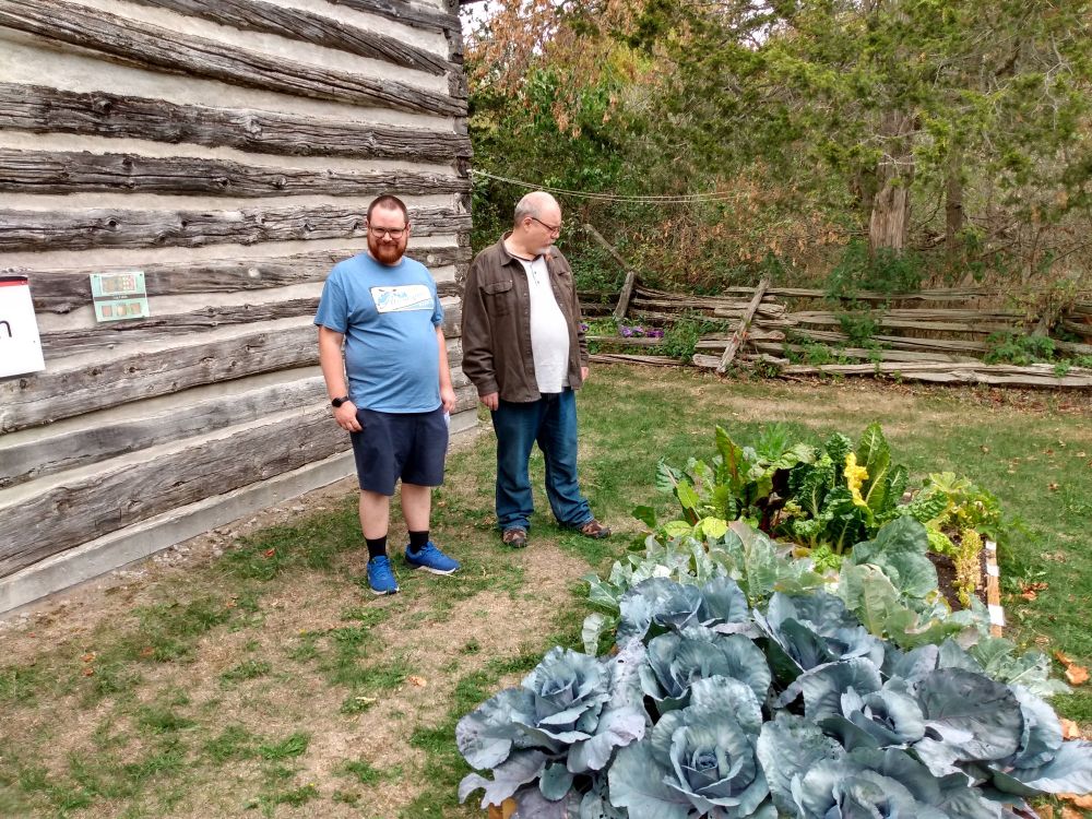 Spyro and Flint intent on examining cabbages in front of a log cabin