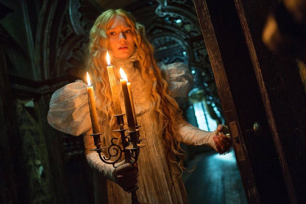 Edith Sharpe at night with a candelabra walking the corridor in Crimson Peak 