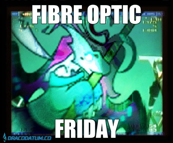 low resolution image of a shark hybrid anthro. it's biting on an undersea internet cable. text reads "FIBRE OPTIC FRIDAY"