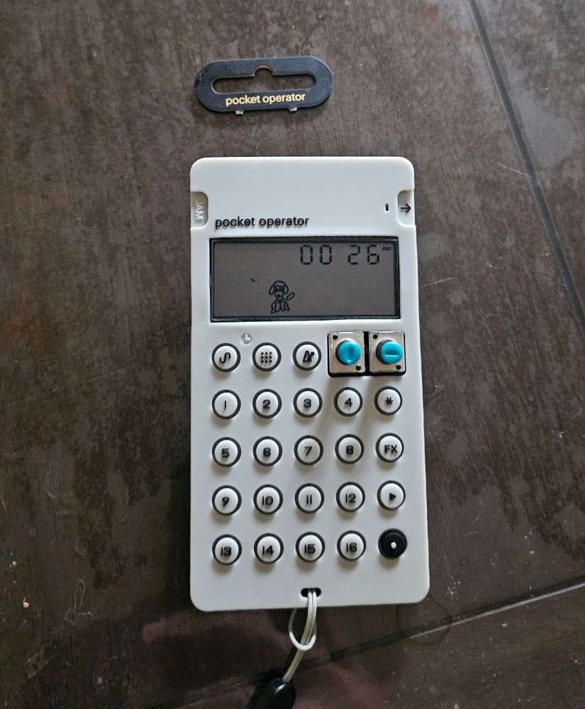 A pocket operator 35 vocal synth with a grey case and a snapped off hanger