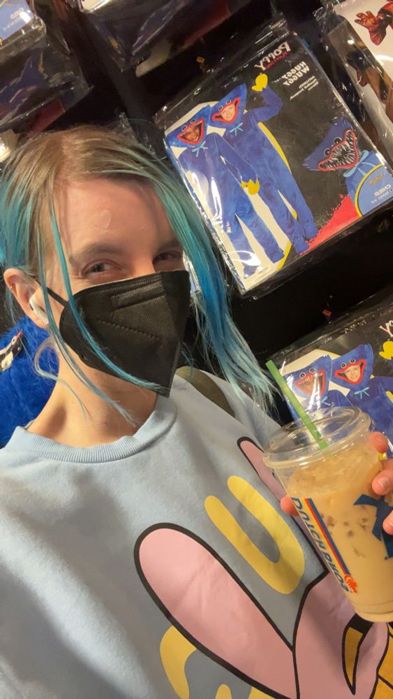 selfie of speedy in front of huggy wuggy costumes at spirit