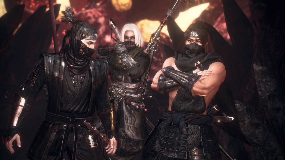 Screenshot taken in photo mode of Nioh 2 of three characters, from left to right: Hattori Hanzo, my co-op partner Kiyo, and my player character Touma. Hanzo is looking to his left, while Kiyo is towards the back playing the flute (through her mask somehow). Touma is crossing his arms. They're standing in the underworld.