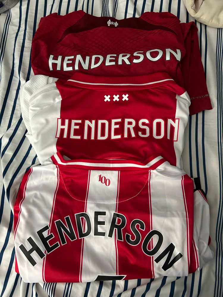 Three Jordan Henderson soccer shirts, from Liverpool, Ajax, and Brentford respectively. All are red and white