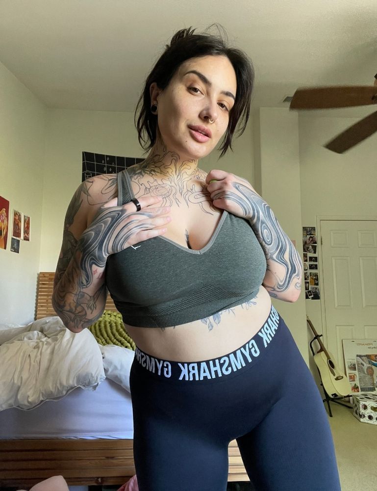 woman looking at you about to take her workout clothes off