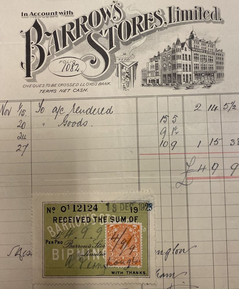 A bill. Top part of the bill has the words Barrows Stores Ltd engraved on it using ornate calligraphy. An illustration of the frontage of a building on the right of the bill. Beneath this, columns capturing information such as dates and charges for services and goods. A coloured docket in the bottom left of the bill identifying payment has been paid. 