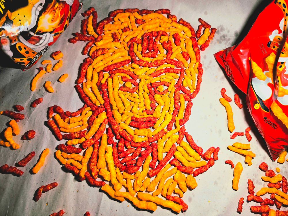 Crunchy Cheetos, in both regular cheddar and Xxtra Flammin' Hot flavors and colors, arranged to look like the bust of Johnny Joestar.