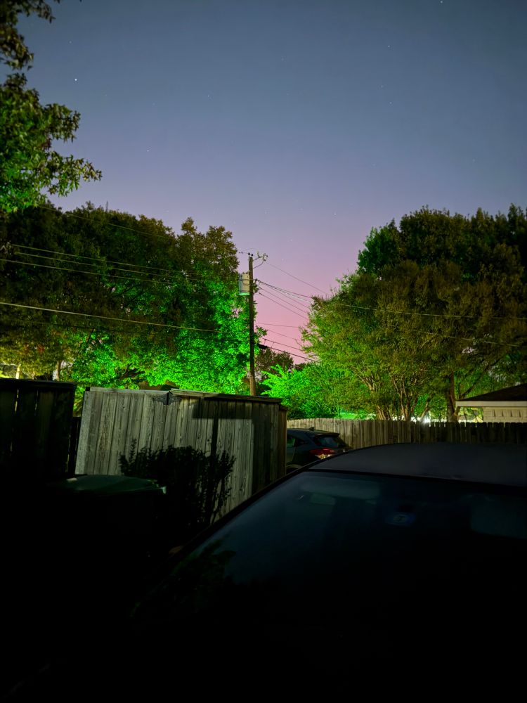 Faint aurora borealis in a suburban backyard