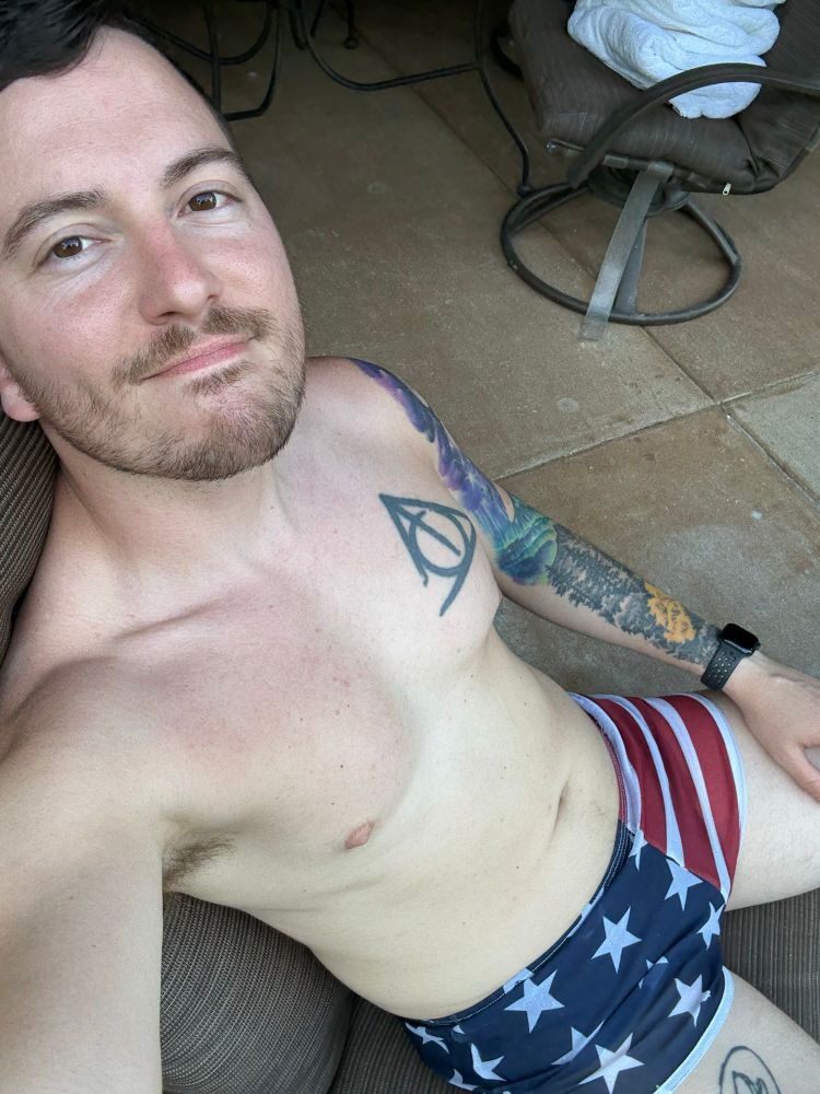 Shirtless Josh sporting a pair of American flag silkies he bought a decade ago.
