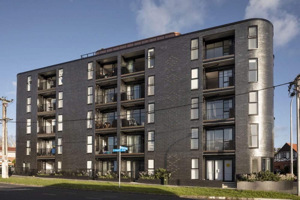 Ockham's 'Modal' building on the corner of Asquith Ave and New North Road. 

The building has a prominent curve and dark glazed brick. It's five stories tall. 

There's a street sign in the foreground.