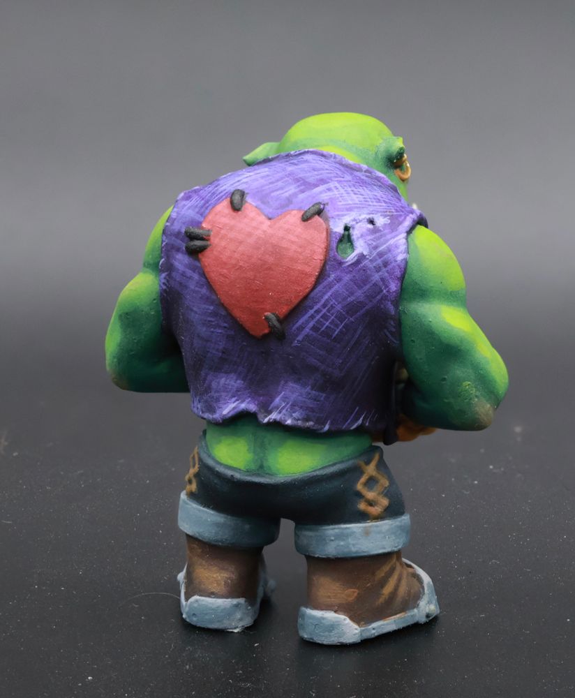 Chibi orc back view. Butt hanging out a little, and heart stitched onto back of the vest. 