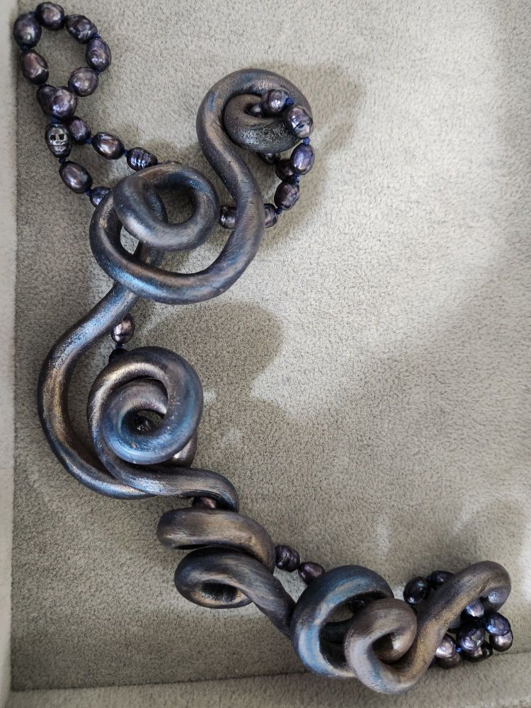 A bluish-purple tentacle necklace with pearls, crafted by glorious Sara Eileen