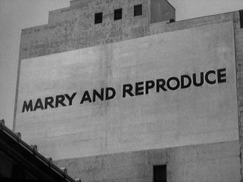 A shot of one of the billboards from They Live, as see through the glasses in black and white, saying "Marry And Reproduce."