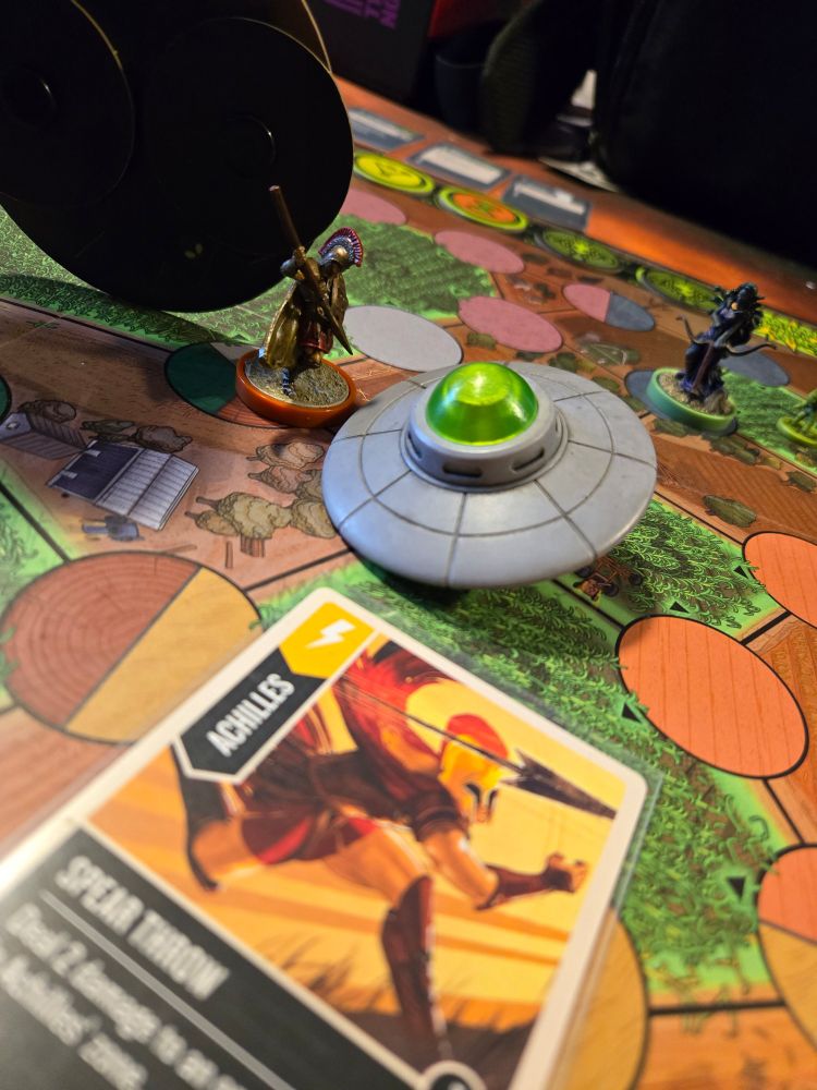 Shows end game state of a game of Unmatched Adventures. The Board has hand-painted miniatures in their final positions.