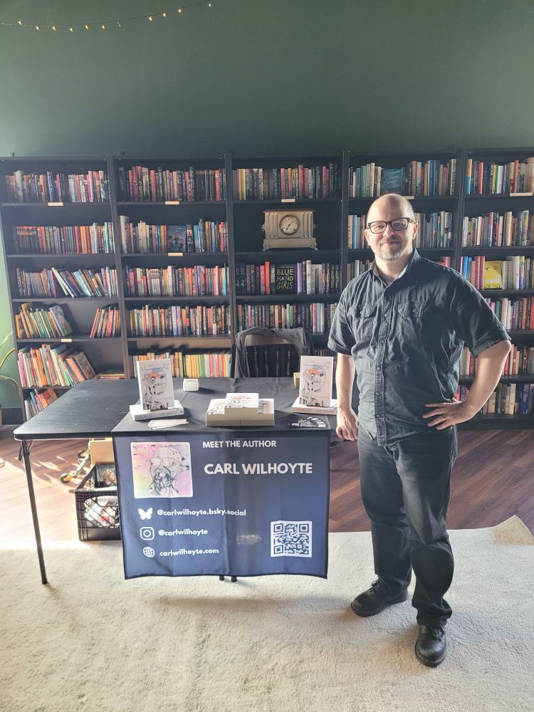 Author Carl Wilhoyte in front of an author table