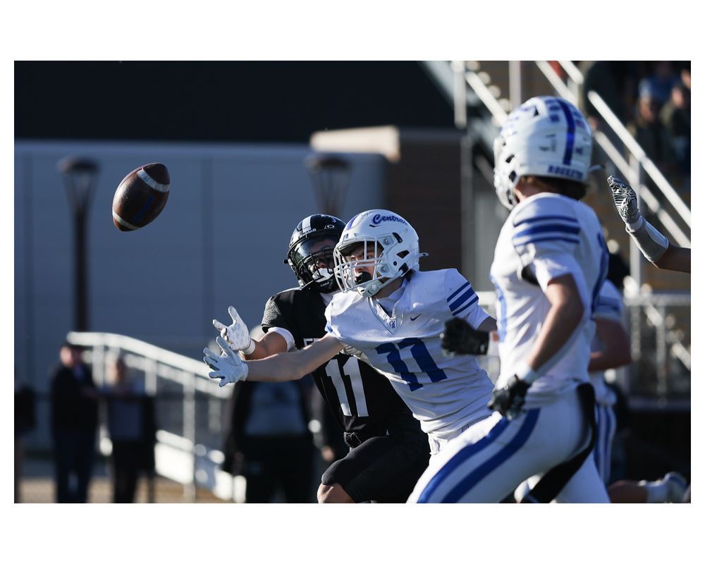Central wide receiver Samuel Ames (11) attempts to catch a pass under pressure from  Fenwick defensive back Odin Ferjak (11)  during a Class 6A state quarterfinals at the George T. Jorndt Athletic Complex in River Grove on Saturday, Nov. 15, 2025. (Talia Sprague / Beacon News)
