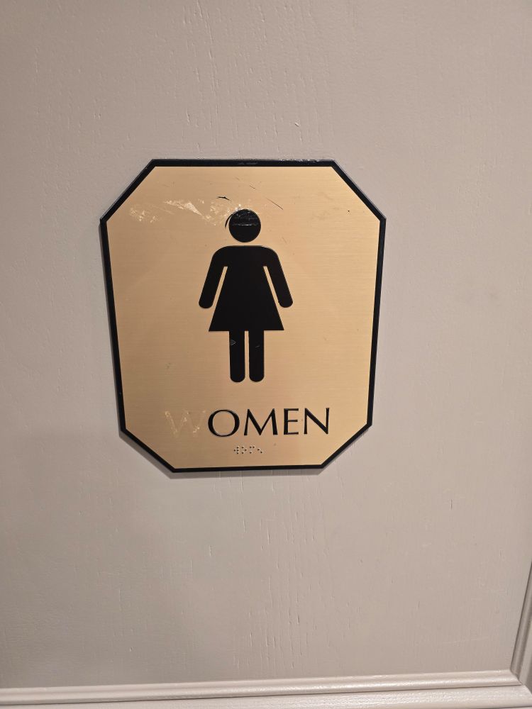 A bathroom sign that says OMEN