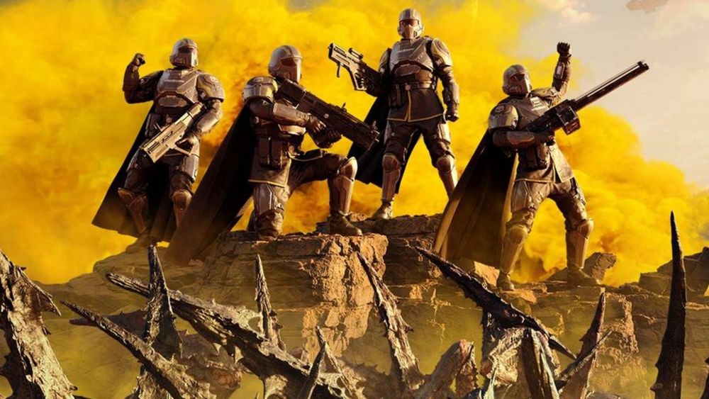 Helldivers 2, with 4 Helldivers celebrating over a pile of defeated Terminid aliens.