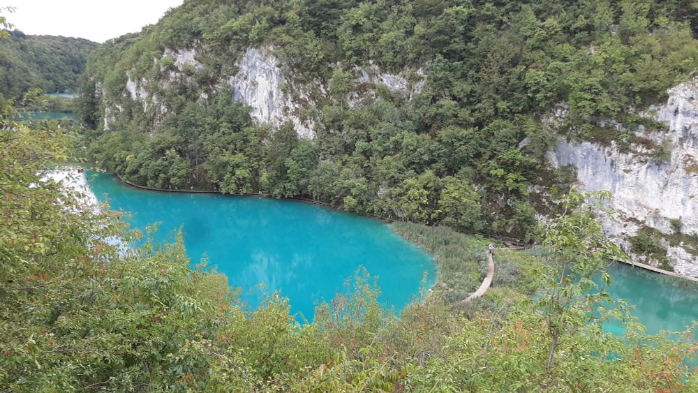 View from atop the canyon showing vividly bright blue water below