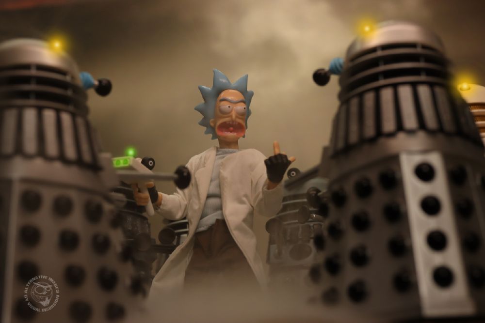 Rick Sanchez is standing in the middle of a circle of daleks. He is flipping them the bird and abusing them. 