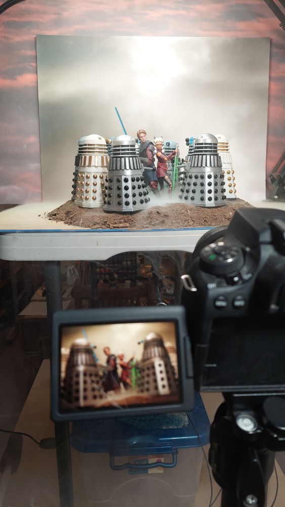 Behind the scenes of the shoot in my kitchen. The room is full of smoke from my portable smoke machine and the camera is showing one of the shots from the shoot with the setup in the background. 