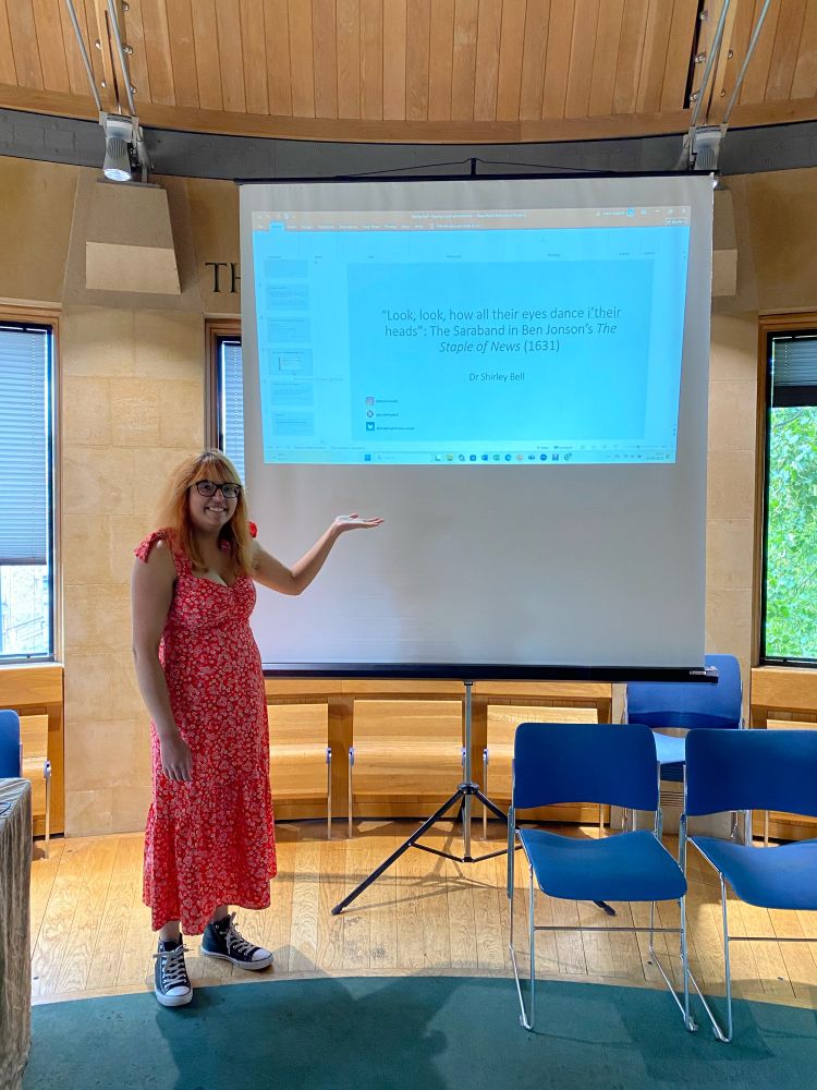 Me standing in front of a screen with my PowerPoint presentation on it.