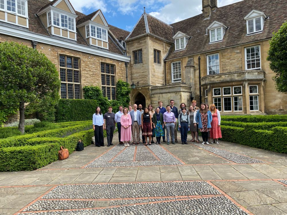 A group of people standing in the courtyard of Emmanuel College, Cambridge.