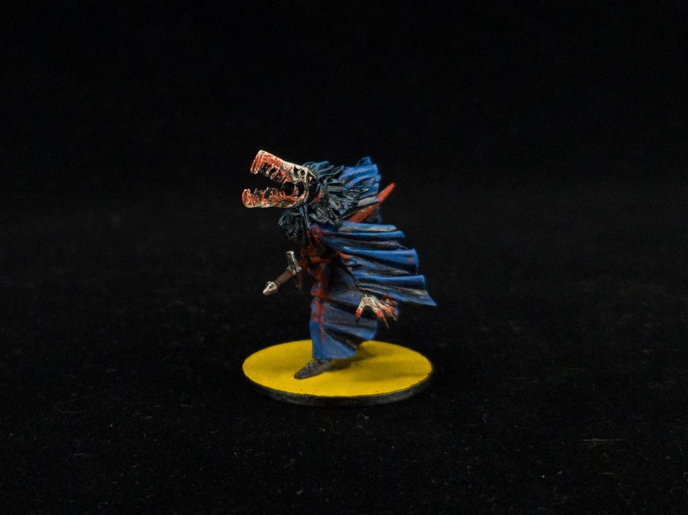 Other side of the Mörk Borg mini showing more skull and blood details.