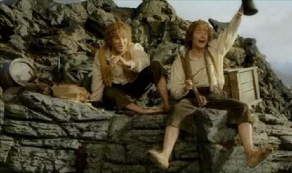 Merry and pippin on a wall in isengard