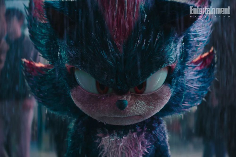A frame from Sonic the Hedgehog 3 (2024) released by Entertainment Weekly.
Shadow stands in the rain, a crowd casually walking past. He seems angry yet introspective.