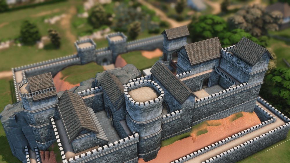 An overhead view of a walled town and grey castle comprising of three successive wards.