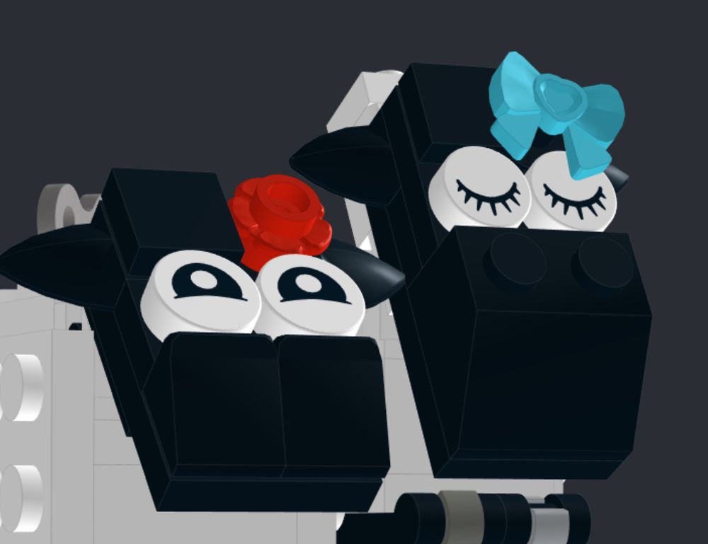 Screenshot of 2 LEGO sheep heads taken in Bricklink's Stud.io. One has closed eyes and an aqua bow on the head, the other happy eyes and a red flower.