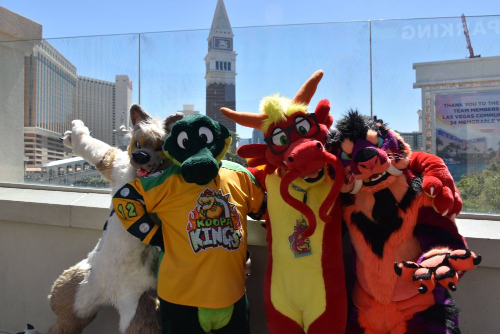 Q8, Croc, Ronnie and Ravertooth posing on a bridge on Las Vegas Strip with the Mirage and Venetian in the background