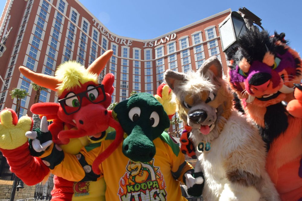 Q8, Croc, Ronnie and Ravertooth posing with the camera at a low angle looking up at the Treasure Island hotel
