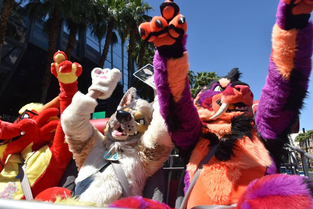 Ronnie, Q8, and Ravertooth riding in the CartZilla with their paws up
