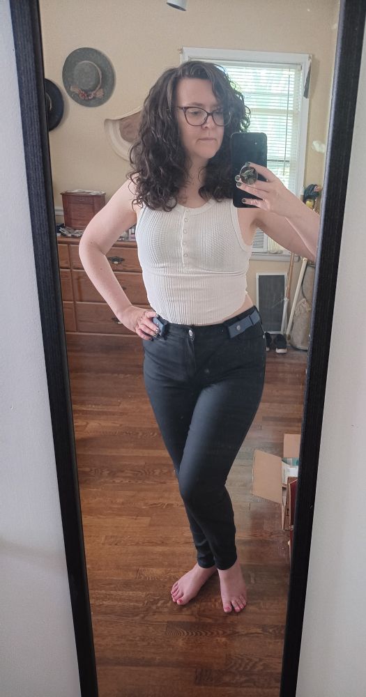 Me in a white crop tank top and black  high waist skinny jeans