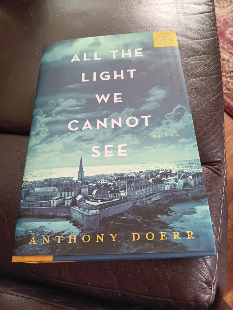 The Book of the Month Club cover of the 'All the Light We Cannot See.' It's a photo of Paris cast in shades of blue.