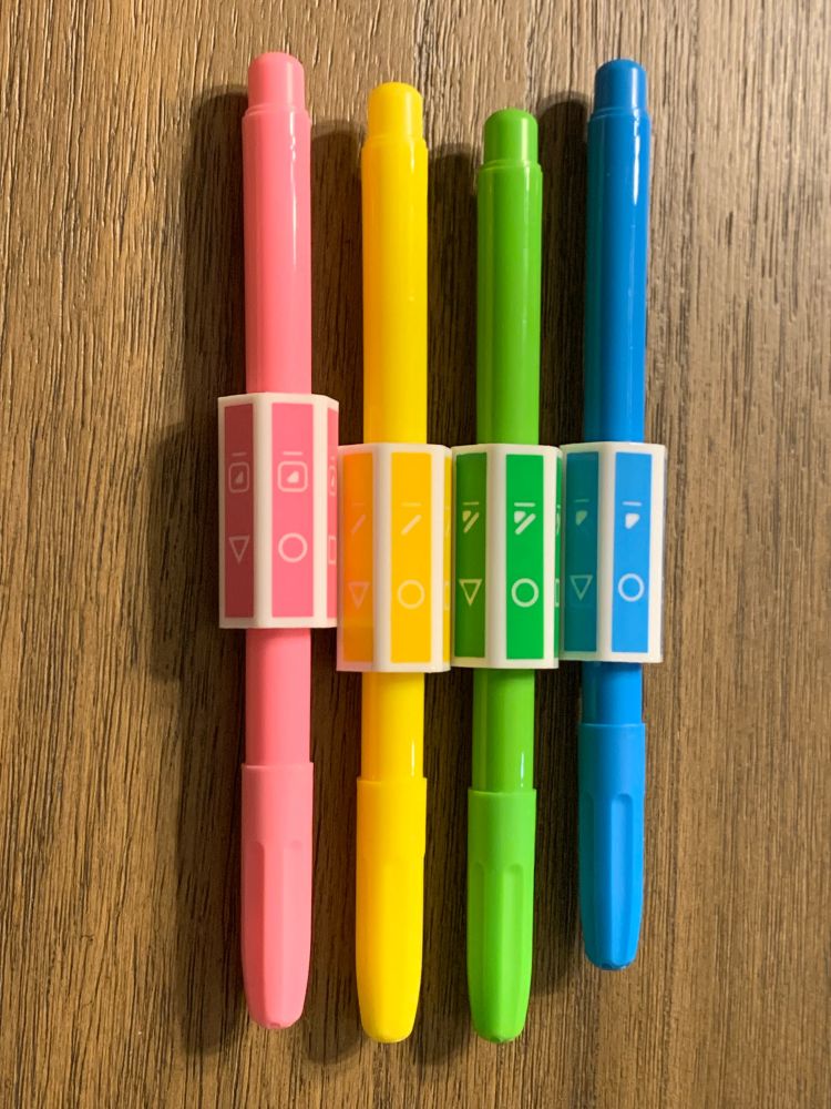 The 4 color pens for the game Takenokolor. From left to right, the pink pen, yellow pen, green pen, and blue pen