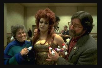 An image of Carl Warmenhoven standing next to a costumed actor while holding bingo daubers.