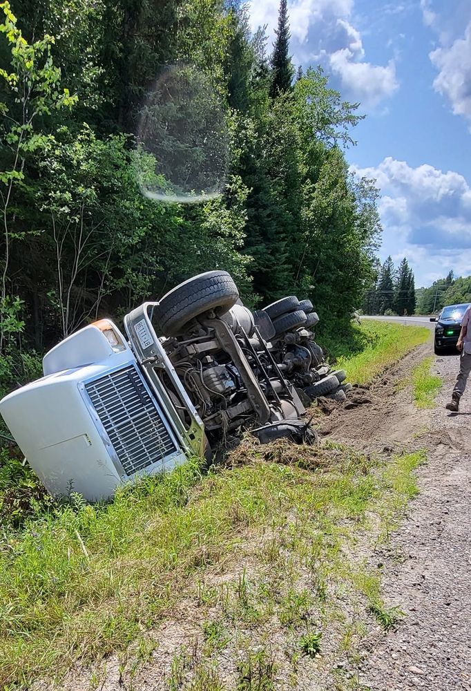 An image of a truck flipped oiver by the side of the road, near Bancroft, Ontario, 7/23/24 https://www.mybancroftnow.com/62838/news/driver-uninjured-after-dump-truck-flips-into-the-ditch