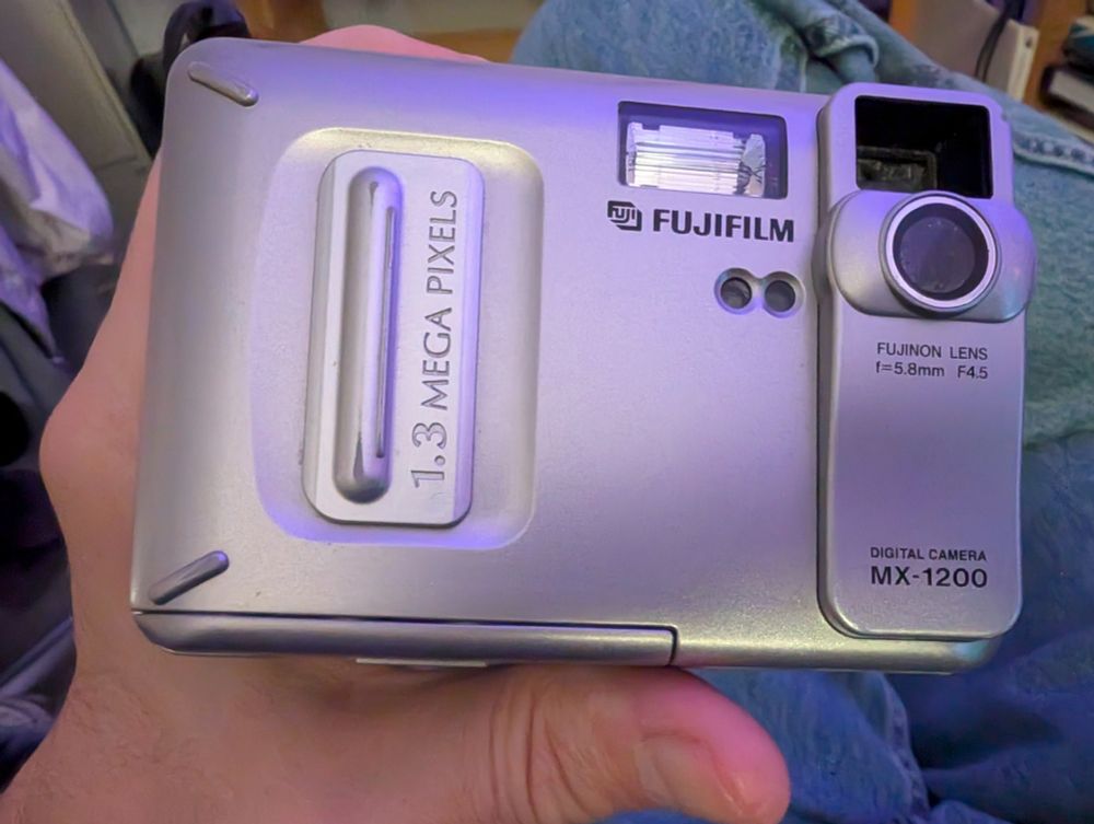 The front view of a Fuji MX-1200 digital camera.